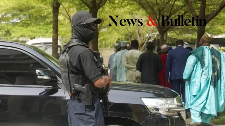 Armed security officer standing near officials amid Nigeria Coup Plot tensions